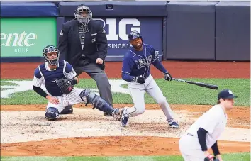  ?? Mike Stobe / Getty Images ?? The Rays’ Manuel Margot hits a two- run home run in the fourth inning against the Yankees at Yankee Stadium on Saturday.