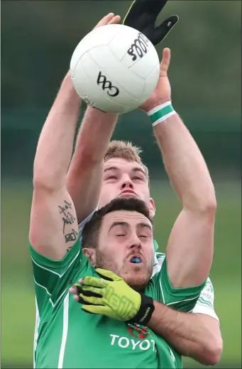  ?? Pictures: Paul Connor ?? Eric Callaghan of Donaghmore/Ashbourne is collared by Michael McNulty (St Patrick’s) on Sunday in Stamullen.