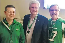  ??  ?? Jeremy Harrison, left, and former premier Brad Wall raised eyebrows when they posed with Stephen Harper at a Roughrider­s game last year.