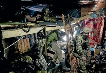  ?? AP ?? Ukrainian paratroope­rs of 80 Air Assault brigade rest inside a dugout at the front line near Bakhmut. Ukraine says the fighting for the strategic city has ‘‘escalated,’’ with Russian forces mounting a fresh offensive.