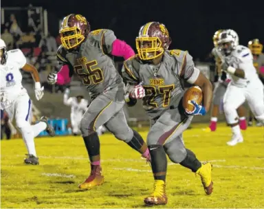  ?? STAFF PHOTO BY DOUG STRICKLAND ?? Tyner’s Tyon Young, right, takes off on a long run with teammate Deandre Williams by his side during Friday’s game at at Tyner High School. Young scored three touchdowns.
