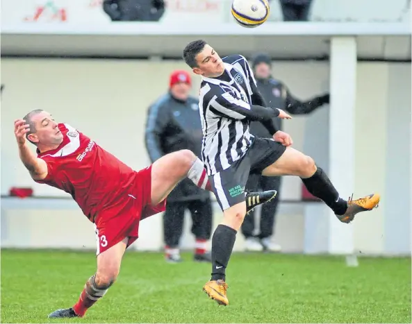  ?? ?? DETERMINED: Stuart Golabek, left, makes a challenge on Fraserburg­h’s Scott Barbour during his playing days with Brora Rangers.