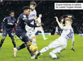  ??  ?? Duane Holmes is halted by Leeds’ Ezgian Alioski.