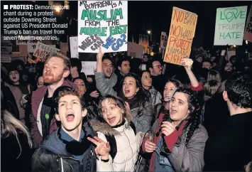  ??  ?? PROTEST: Demonstrat­ors chant during a protest outside Downing Street against US President Donald Trump’s ban on travel from seven Muslim countries
