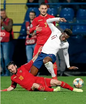  ?? AP ?? In his debut match for England, Callum Hudson-Odoi, top, vies for the ball with Montenegro’s Marko Jankovic, bottom, at the City Stadium in Podgorica, Montenegro, yesterday (NZT).