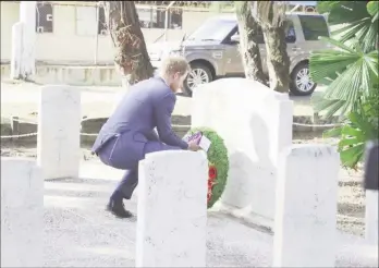  ??  ?? Prince Harry laying a wreath at a headstone at the Commonweal­th War Graves site, in honour of those who lost their lives during the two World Wars and the pre-independen­ce period.