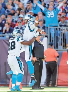  ?? GREG M. COOPER, USA TODAY SPORTS ?? Carolina quarterbac­k Cam Newton celebrates with running back Jonathan Stewart after a touchdown in the 33-30 win at New England.