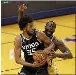  ?? EZRA SHAW — GETTY IMAGES ?? The Warriors’ Draymond Green draws an offensive foul on the Kings’ Marvin Bagley III at Chase Center in San Francisco on Monday.