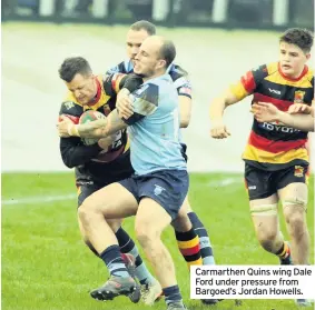  ??  ?? Carmarthen Quins wing Dale Ford under pressure from Bargoed’s Jordan Howells.