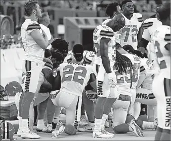  ?? [RON SCHWANE/THE ASSOCIATED PRESS] ?? Several members of the Browns kneel during the national anthem.