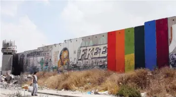  ??  ?? Khaled Jarrar’s work on the West Bank wall