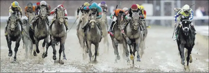  ?? Matt Slocum The Associated Press ?? John Velazquez, far right, rides post-time favorite Always Dreaming to victory Saturday in the 143rd running of the Kentucky Derby on a sloppy track at Churchill Downs.