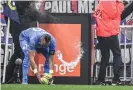  ?? Philippe Desmazes/AFP/Getty Images ?? Dimitri Payet is struck in the head with a water bottle thrown by a Lyon fan. Photograph: