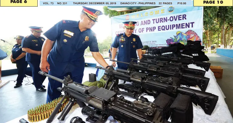  ?? BING GONZALES ?? POLICE Regional Office XI regional director, Brig. Gen. Filmore Escobal, and deputy regional director for administra­tion, Brig. Gen. Domingo Cabillan, inspect the new firearms during the turnover ceremony of equipment to respective provincial offices in Camp Quintin Merecido on Wednesday.