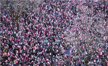  ??  ?? PARIS: Supporters of conservati­ve presidenti­al candidate Francois Fillon listen during a rally in Paris. —AP