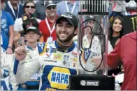  ?? WESLEY BROOME - THE ASSOCIATED PRESS ?? Chase Elliott poses with the trophy after winning the NASCAR Cup Series auto race at Charlotte Motor Speedway in Concord, N.C., Sunday.