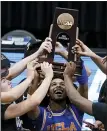  ?? DARRON CUMMINGS — THE ASSOCIATED PRESS ?? UCLA guard Tyger Campbell (10) celebrates with teammates after an Elite 8game against Michigan on Wednesday at Lucas Oil Stadium in Indianapol­is.