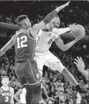  ?? Lance King Getty Images ?? SHAMORIE PONDS of St. John’s shoots over Javin DeLaurier. Duke lost for second time in three games.