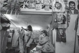  ?? RAMON ESPINOSA AP ?? A woman waits to be shown a dress in a private clothing and craft store in Havana, Cuba, on Sept. 16, 2021. The U.S. Treasury Department has allowed a company headed by John Kavulich to invest in and lend money to a small private business in the service sector in Cuba.