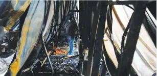  ?? (Khalid al-Mousily/Rueters) ?? A WORKER inspects the damage from a fire at al-Hussain coronaviru­s hospital in Nassiriya, Iraq, yesterday.