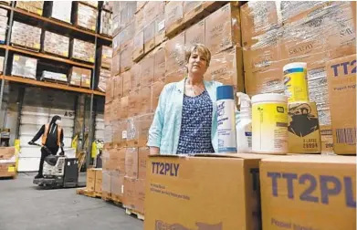  ?? KENNETH K. LAM /BALTIMORE SUN ?? Maggie Duerr, ACME Paper & Supply Co. customer satisfacti­on manager, has been integral in sourcing thousands of products during the COVID-19 pandemic to hospitals, nursing homes and first responders.