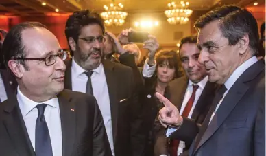  ??  ?? French President Francois Hollande, left, talks with Francois Fillon, the conservati­ve candidate for the French presidenti­al elections in Paris in this file photo. (AP)