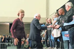  ?? MICHAEL SEARS/MILWAUKEE JOURNAL SENTINEL ?? Sen. Tammy Baldwin (left) and Sen. Bernie Sanders greet supporters Monday at a rally at UW-Milwaukee for Democratic candidates running for office this fall.