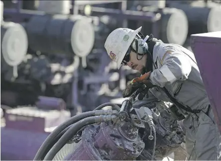  ?? BRENNAN LINSLEY/AP ?? A worker oils a pump during a hydraulic fracturing operation near Mead, Colo. GMP FirstEnerg­y analyst Martin King expects oil prices to rise despite concerns about the surging U.S. shale output.