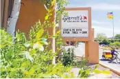  ?? GABRIELA CAMPOS/THE NEW MEXICAN ?? A pedicab passes by Garrett’s Desert Inn on Thursday. The State Land Office this week may recommend the commission­er accept one of three bids to lease the Garrett’s Inn property.