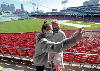  ??  ?? WHAT A SHOT! Mother and daughter, Abby Hernois, left, and Chris Healey take a Fenway Park selfie after voting. Below, voters pick up ballots.