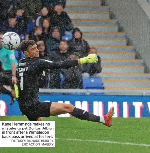  ?? PICTURES: RICHARD BUIRLEY, EPIC ACTION IMAGERY ?? Kane Hemmings makes no mistake to put Burton Albion in front after a Wimbledon back pass arrived at his feet.