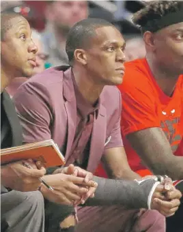  ??  ?? Guard Rajon Rondo sports a cast on his right thumb while sitting on the bench Friday during Game 3 of the Bulls’ playoff series against the Celtics at the United Center.