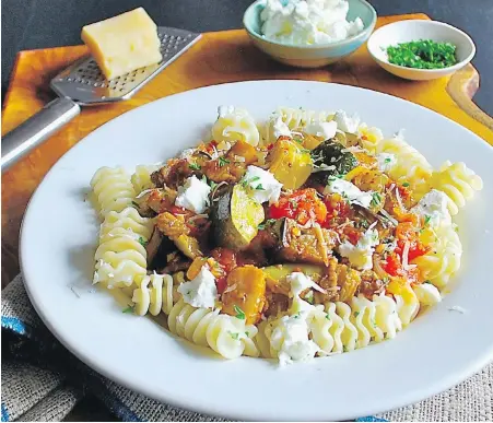  ?? ERIC AKIS ?? Bite-size pasta is topped with the southern France-style stew ratatouill­e and two types of cheese for a hearty vegetarian meal.