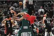  ?? ASSOCIATED PRESS ?? Milwaukee’s Grayson Allen delivers a hard foul to Chicago’s Alex Caruso in the second half Friday. Allen was charged with a flagrant 2 and ejected.