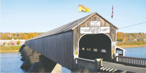  ?? PHOTOS GETTY IMAGES ?? At 1,282 feet, the longest wooden covered bridge in the world is over the Saint John River in Hartland, N.B.