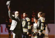  ?? Michael Dwyer / Associated Press ?? Hockey Hall of Famer Willie O’Ree, left, waves to the crowd before dropping the ceremonial puck before a game between the Boston Bruins and the Edmonton Oilers in Boston in 2020.