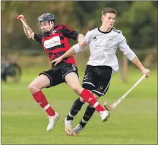  ?? Photograph: Neil Paterson. ?? Oban Camanachd’s Daniel MacCuish is marked closely by Lovat’s Craig Mainland.