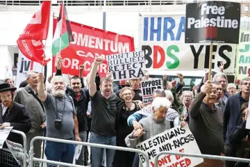  ??  ?? Demonstrat­ors hold placards as they protest outside the headquarte­rs of Britain’s opposition Labour party in central London. — AFP photo