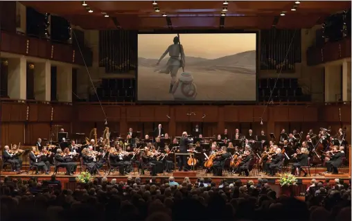  ?? Scott Suchman ?? The National Symphony Orchestra performs the score of “Star Wars: The Force Awakens” while it is played onscreen at the Kennedy Center.