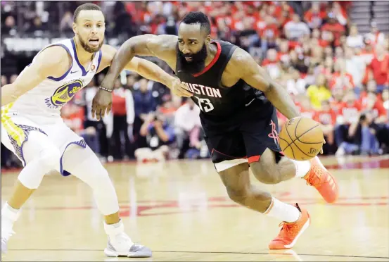  ??  ?? Houston Rockets guard James Harden (13) drives around Golden State Warriors guard Stephen Curry (30) during the second half of Game 1 of the NBA basketball Western Conference Finals
on May 14, in Houston. (AP)