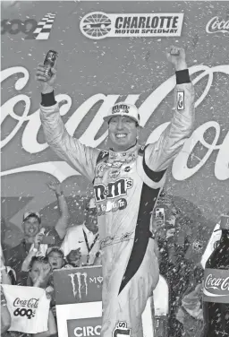  ?? BRIAN LAWDERMILK/GETTY IMAGES ?? Kyle Busch celebrates in victory lane after winning the Coca-Cola 600 at Charlotte Motor Speedway on Sunday in Charlotte, N.C.