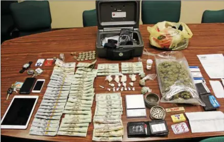  ?? PHOTO COURTESY ONEIDA CITY POLICE ?? Police seized the pictured drugs, parapherna­lia, cash, electronic devices, and personal items after executing a search warrant at the Super 8Motel room where Oscar Davis, a parolee, was residing.