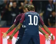  ?? FRANKE FIFE/AFP/GETTY IMAGES ?? Paris Saint-Germain’s Dani Alves celebrates with teammate Neymar after a goal against Bayern Munich on Wednesday in Champions League action.