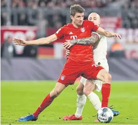  ??  ?? Bayern Munich’s Thomas Mueller, left, vies with Leipzig’s Angelino.