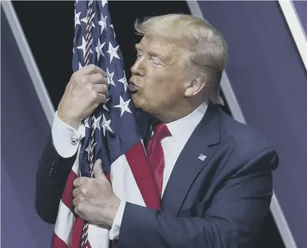  ?? PICTURE: JOSE LUIS MAGANA/AP ?? 0 Donald Trump kisses the American flag after speaking at the CPAC event