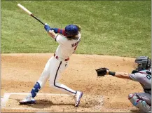  ?? CHRIS SZAGOLA — ASSOCIATED PRESS ?? The Phillies’ Bryce Harper, left, hits a three-run home run during the first inning Sunday.