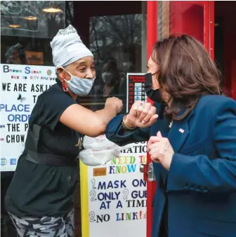  ?? KAMIL KRZACZYNSK­I/AFP VIA GETTY IMAGES PHOTOS ?? Vice President Kamala Harris is greeted by a worker outside of the Brown Sugar Bakery on Tuesday during Harris’ visit to Chicago.