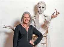  ??  ?? Nelson artist Sally Burton with the Arthur Wakefield figure she made out of wood and tapa cloth.