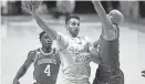  ?? SAUL YOUNG/NEWS SENTINEL ?? Tennessee's Santiago Vescovi, center, shoots while guarded by Arkansas' Jordan Walsh, right, during a Feb. 28 game in Knoxville. Vescovi won't play for the Vols vs. Michigan State in a charity exhibition game on Sunday.