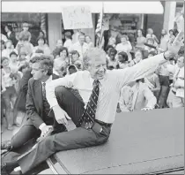  ?? BOB DAUGHERTY – THE ASSOCIATED PRESS ?? President Jimmy Carter waves from the roof of his car along the parade route through Bardstown, Ky., on July 31, 1979.